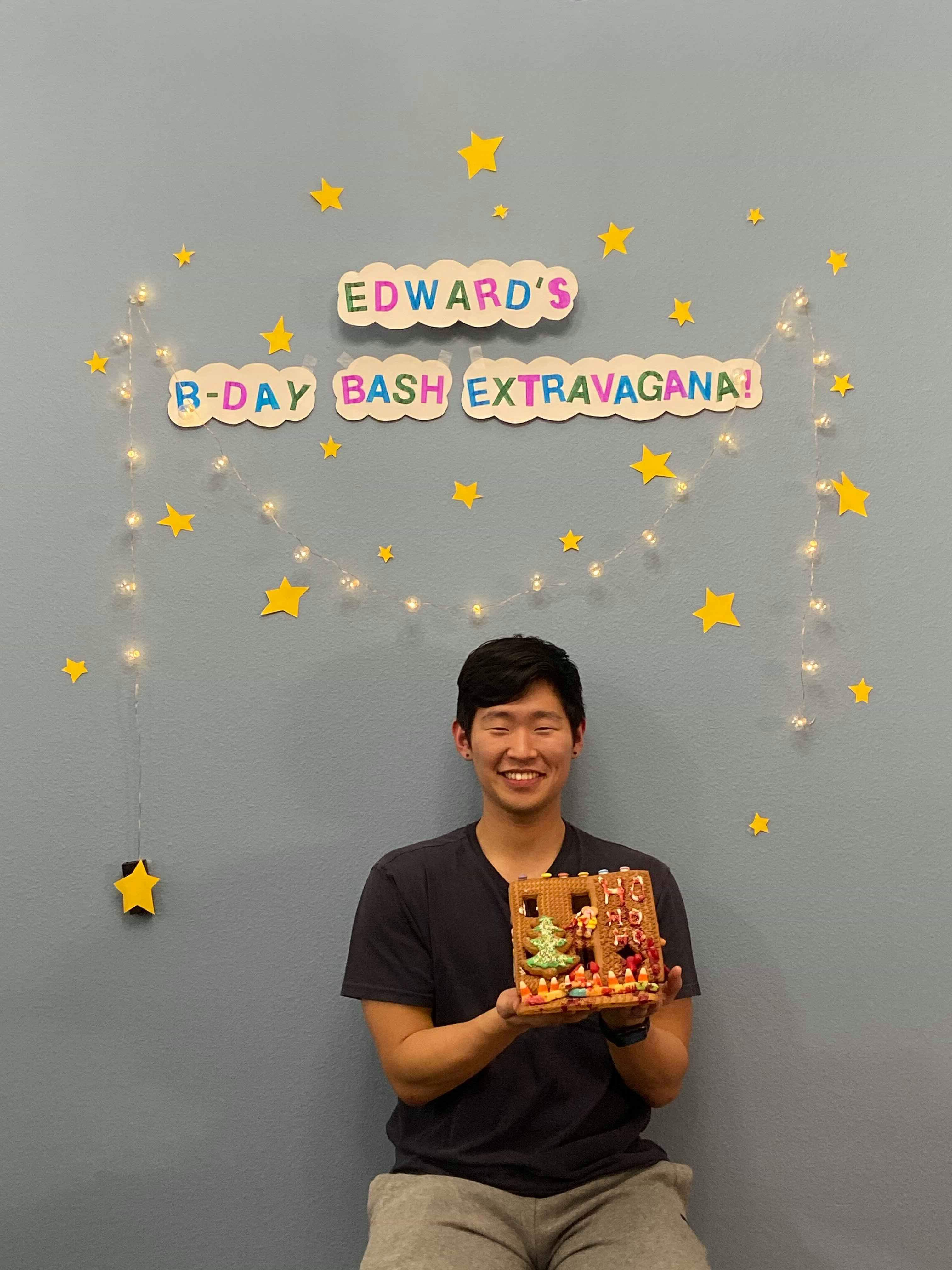 edward smiling posing under a birthday sign